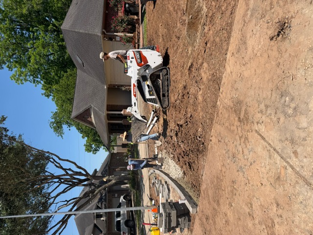 Apex crew and compact track loader completing residential drainage work
