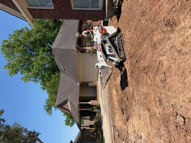 Apex operator grading soil with a compact track loader