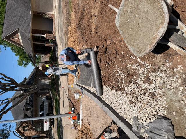 Apex crew preparing geotextile fabric in a drainage trench